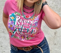 a woman wearing a pink t - shirt that says praise the lord